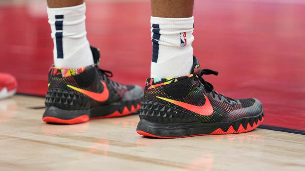 View of black and red Nike Kyrie shoes.